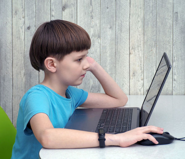 Young woman using laptop at home