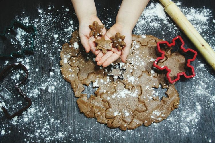 Cropped image of child holding star shape cookies