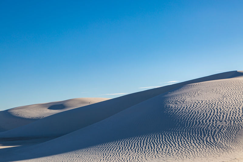 Light and shadow on the gypsum sand dunes, at white sands national monument, new mexico