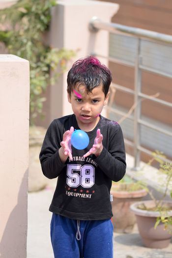 Boy playing with water bomb during holi