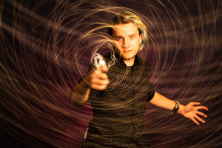 Portrait of man spinning wire wool 
