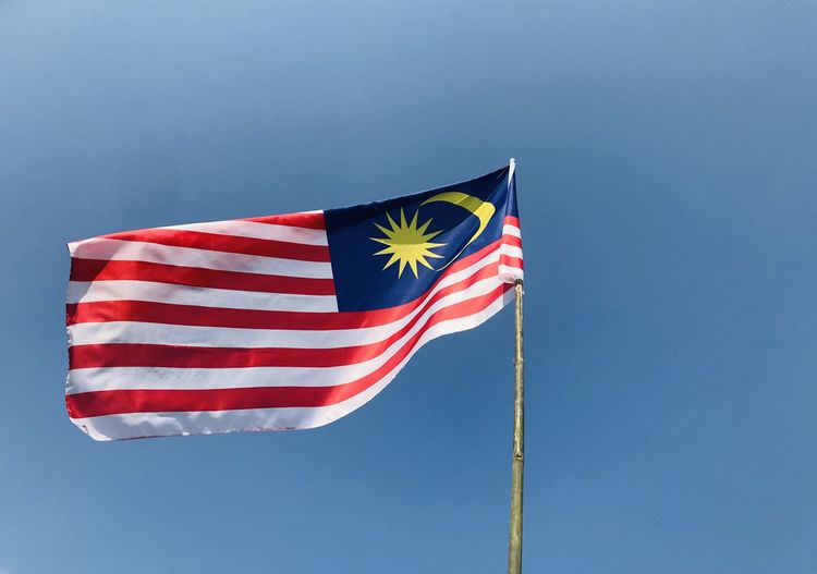 Low angle view of flag against sky