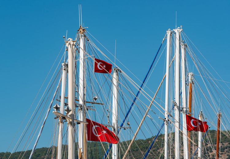 Ship mast in the port of bodrum, turkey in front of cloudless sky