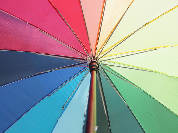 Low angle view of umbrella bright colorful rainbow umbrella background lgbt concept