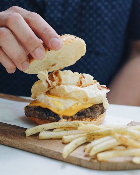 Man holding gourmet burger
