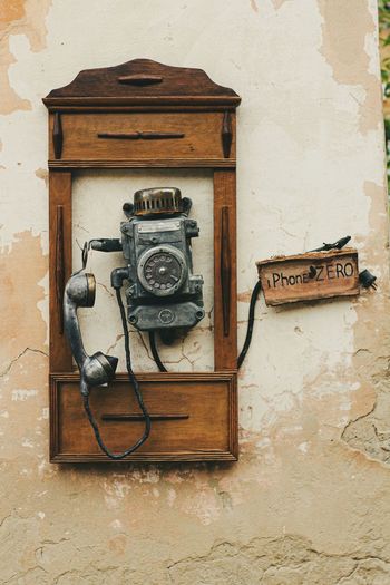 Close-up of old telephone on wall