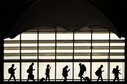 GROUP OF PEOPLE WALKING ON AIRPORT