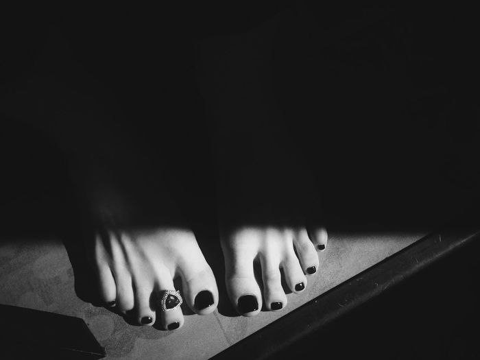 Light falling on toes of woman