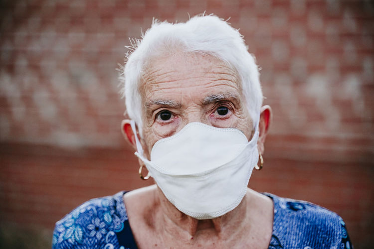 Close-up portrait of senior woman wearing mask