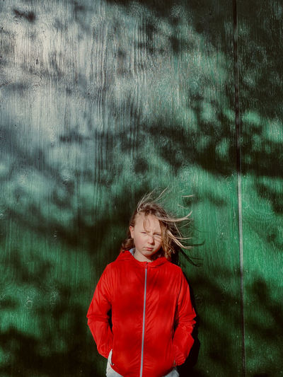 Portrait of girl standing at the wall 