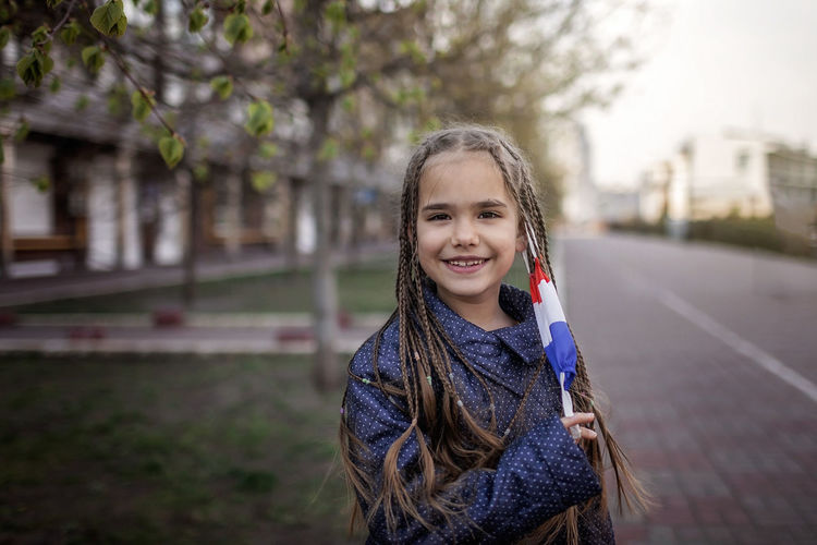 Portrait of girl standing on street