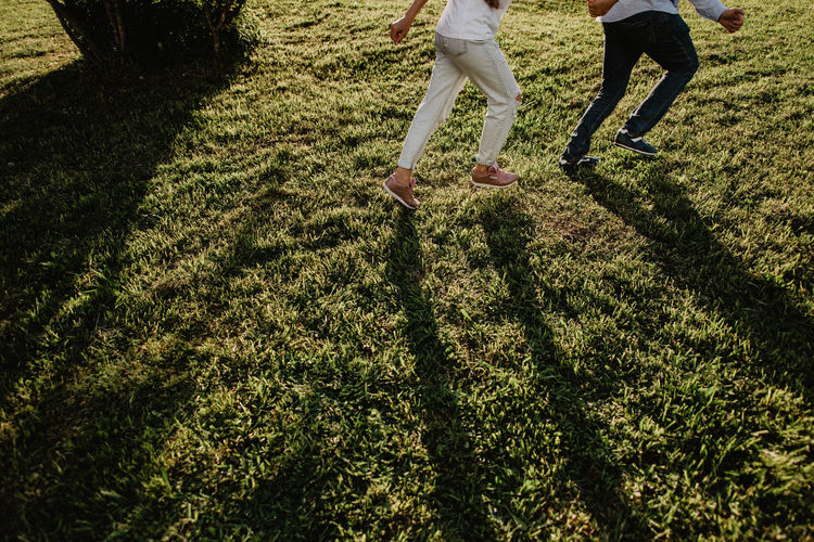 LOW SECTION OF PEOPLE ON FIELD BY PLANTS