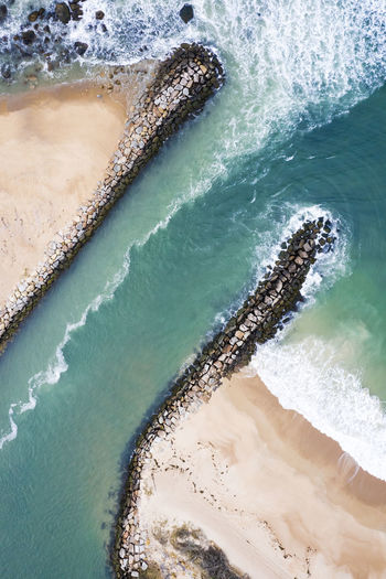 Aerial view of a jetty and beach in new england
