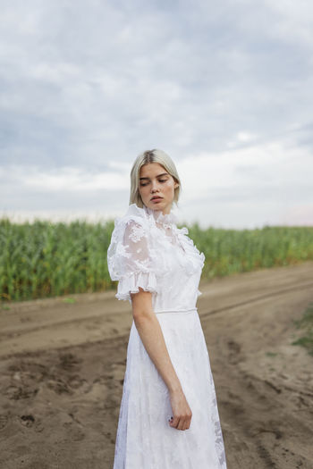 Woman in white dress walks in nature