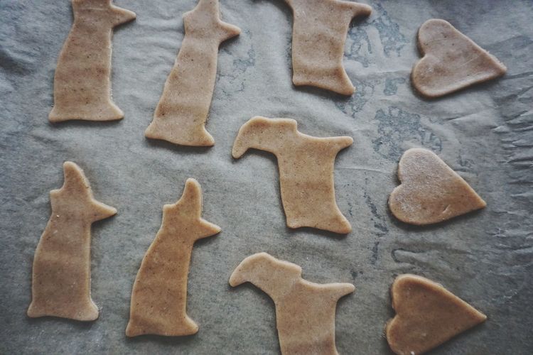 Close-up of various shape cookies on baking sheet