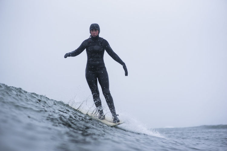 Woman surfing during winter snow