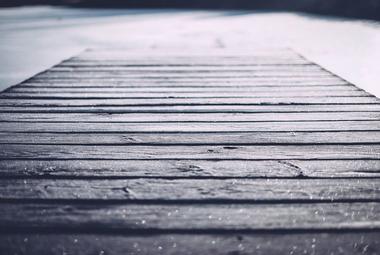Close-up of boardwalk during winter