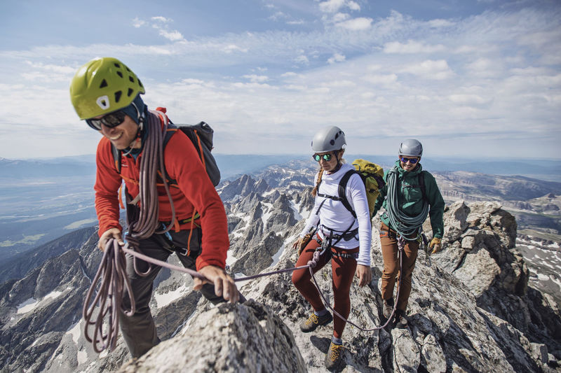 Climbing guide leads two clients to the summit of the grand teton