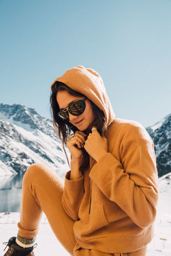A cozy woman overlooks a breathtaking view in the mountains