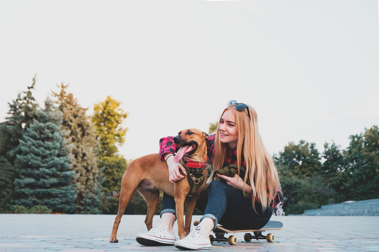 Young woman with dog on the background