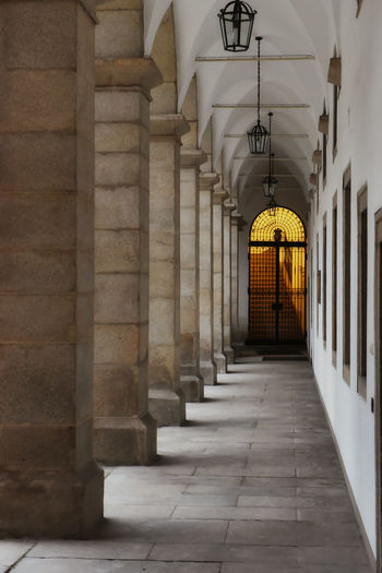 Perspective of an old magnificent corridor with powerful pillars