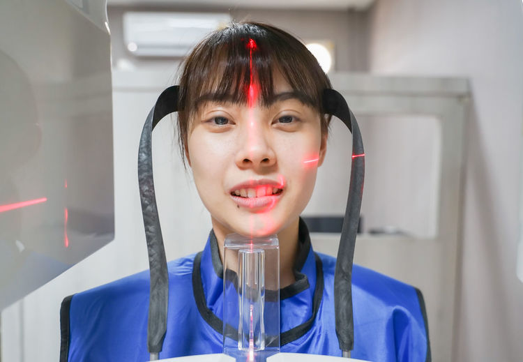 Close-up portrait of smiling woman with medical equipment