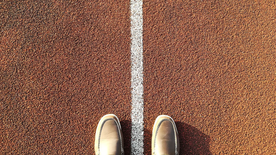 Directly above shot of shoes on running track