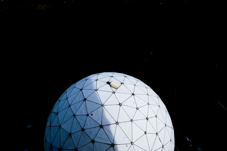 Close-up of glass against clear blue sky at night