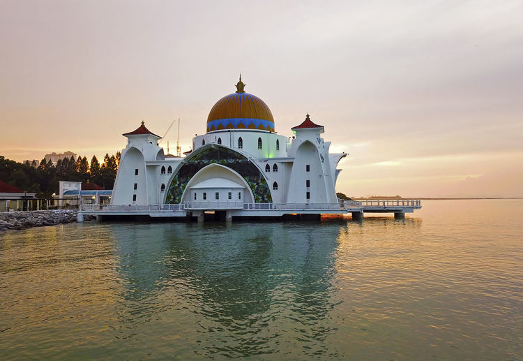 View of majestic malacca straits mosque  against sky during sunset