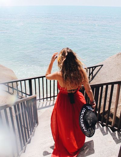 Woman walking against sea