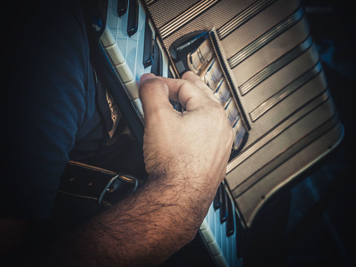 Cropped image of man playing accordion