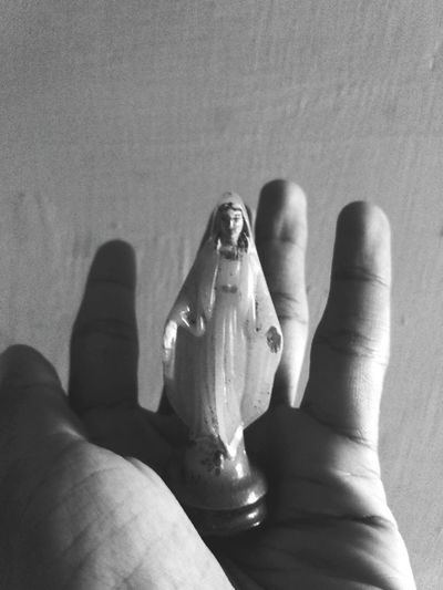 Low section of man holding figurine