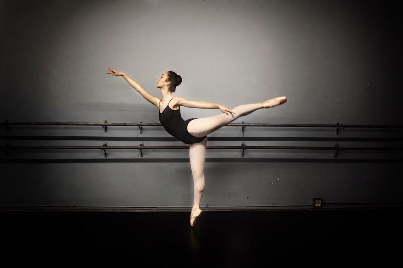 Young woman practicing ballet in dance studio