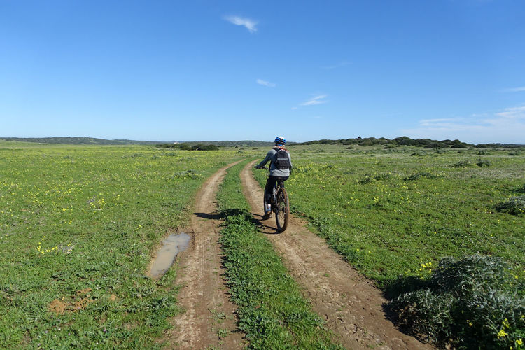 Teenager riding an electric mountain bike on a remote country track