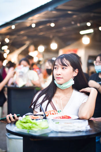 Woman eating food in restaurant