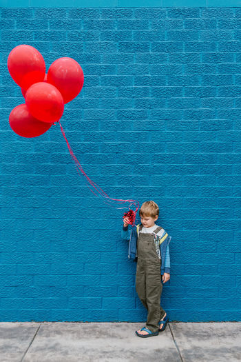 Boy holding balloon balloons