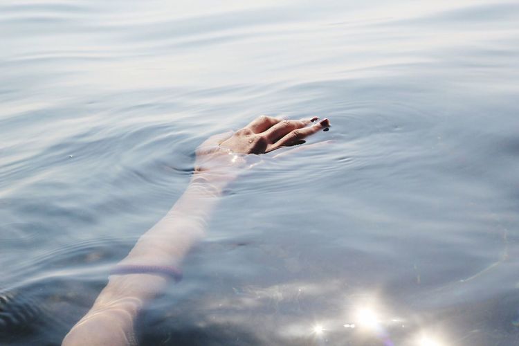 Close-up of hand floating in water