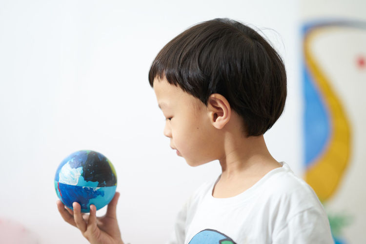 Boy looking at globe