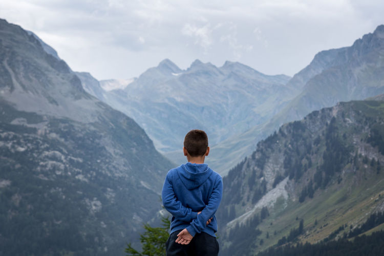 Rear view of boy looking at mountain range