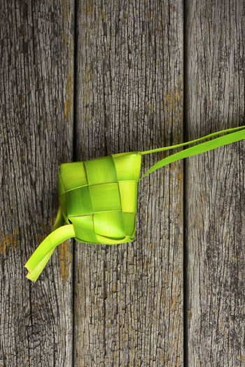 Close-up of green toy on table against wall