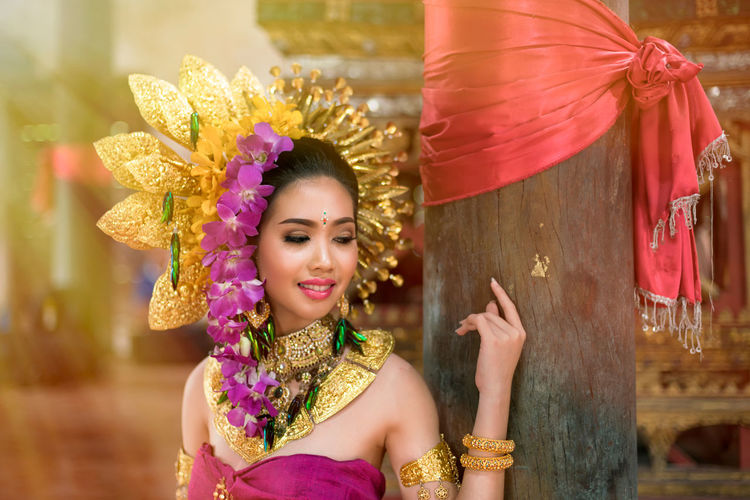 Portrait of happy young woman dancing in traditional clothing