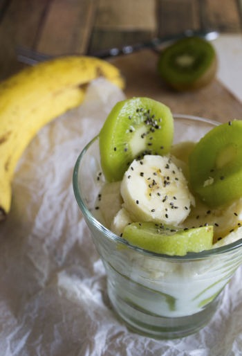 Close-up high angle view of fruits in drinking glass on table