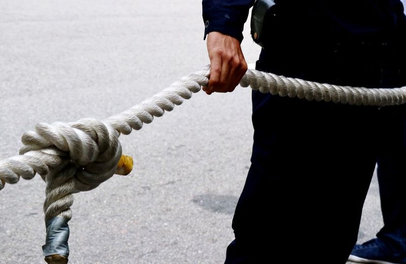 Midsection of person holding rope 