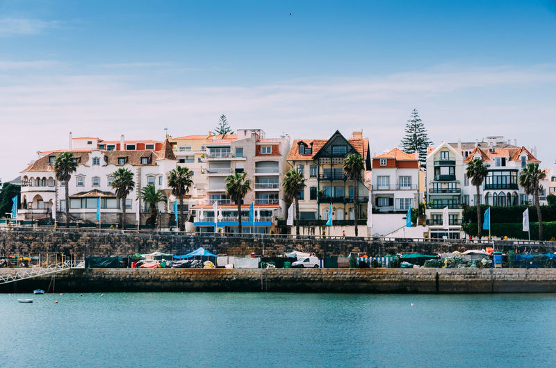 View of the beautiful cascais bay with traditional residential buildings next to the famous bay