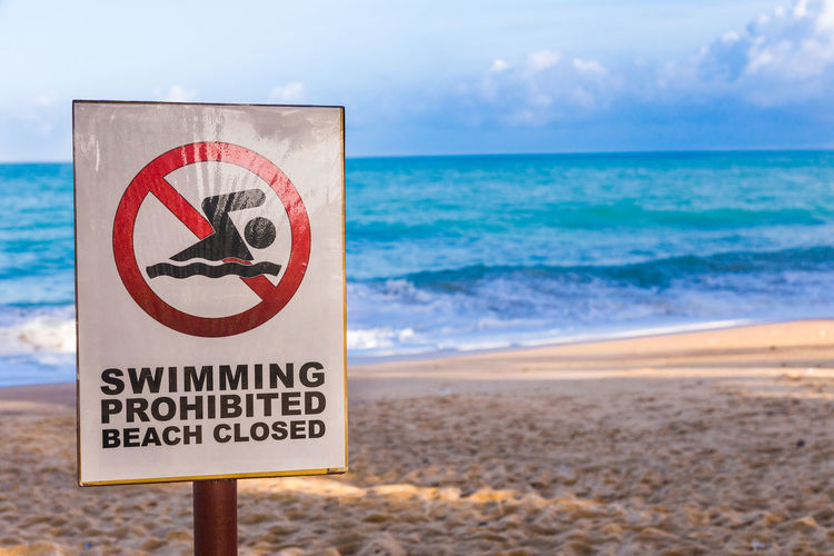 Swimming prohibited sign posts at a beach in phuket, thailand