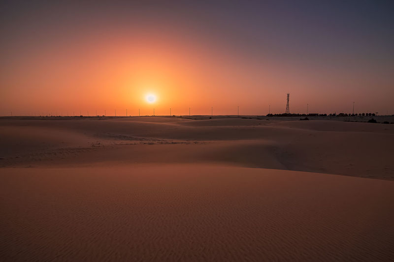 Scenic view of beach against sky during sunset
