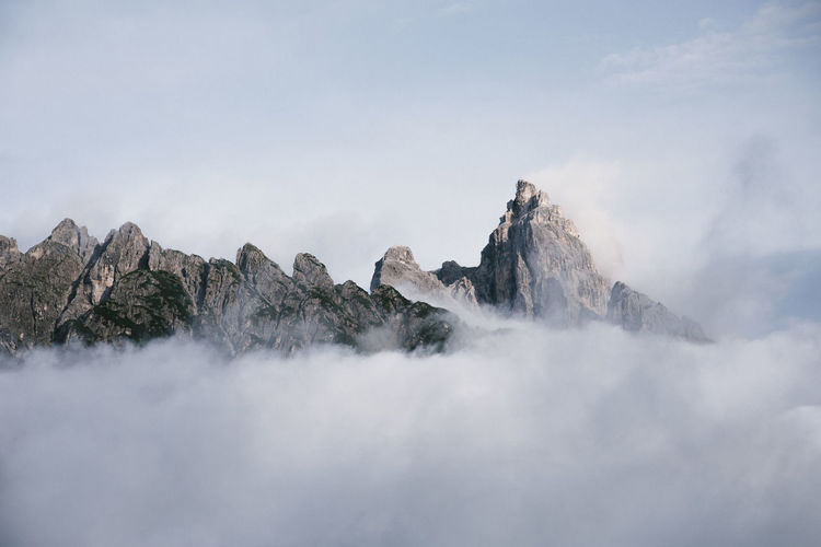 Scenic view of rocky mountains against cloudy sky