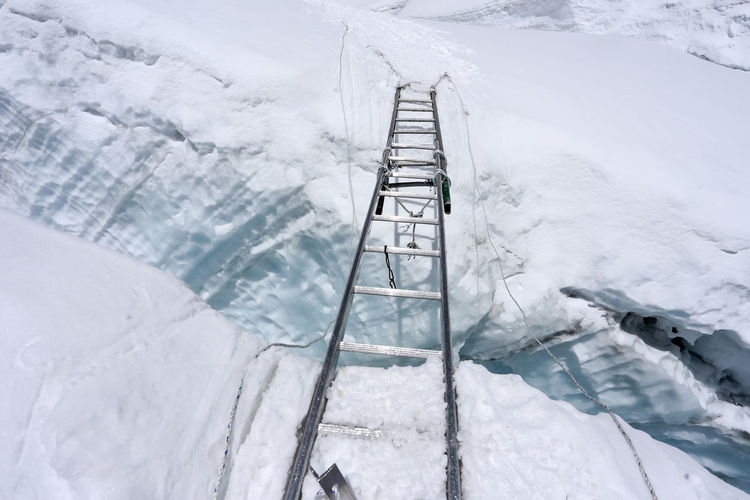 High angle view of ladder on snow covered ladder