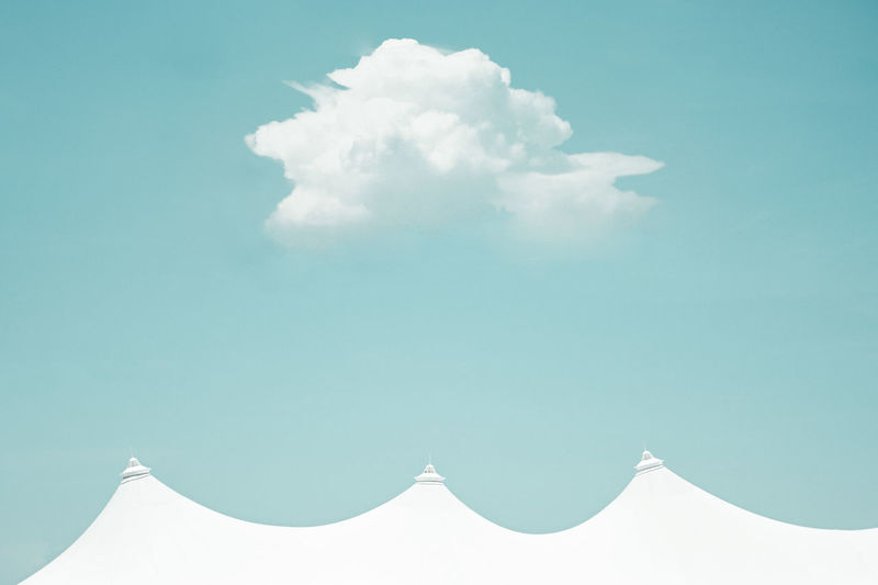 High section of tent against cloudy sky