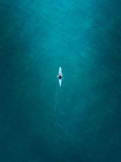 Aerial view of man kayaking in sea